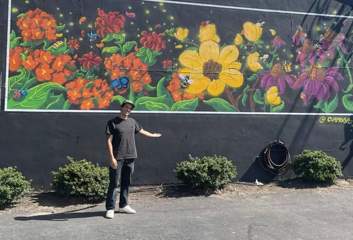 NHS graduate Anthony Cuadros livens up bare wall with colorful mural