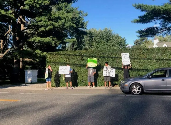 Protestors line up in front of Northwell Health CEO’s home as vaccine mandates go into effect for NYS health care workers